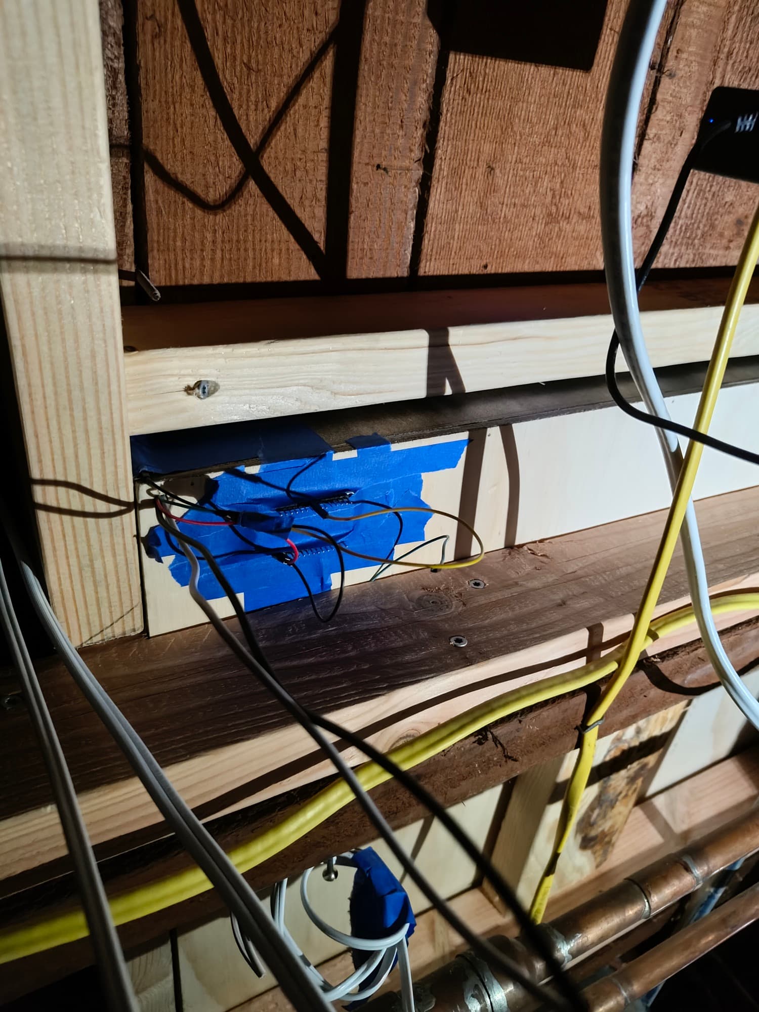 Controllers taped into a wall cavity, wired and hidden